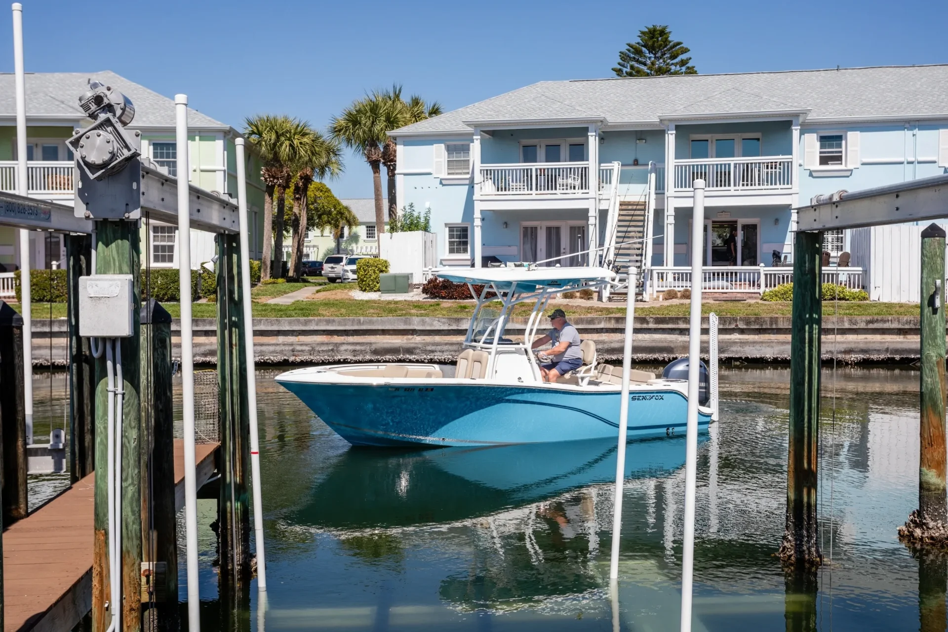 A boat is in the water near some houses.