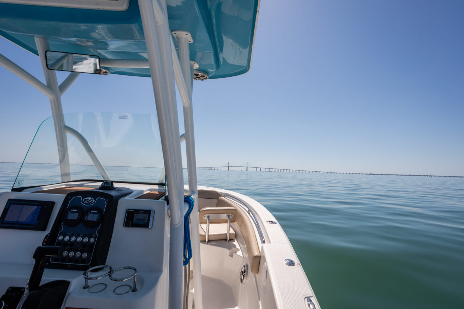 A boat is sailing on the water near some piers.