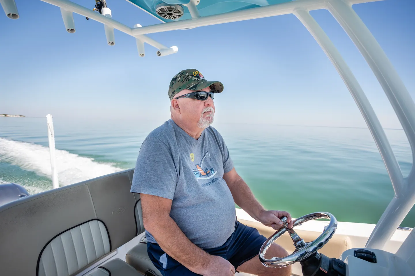 A man driving a boat on the water.