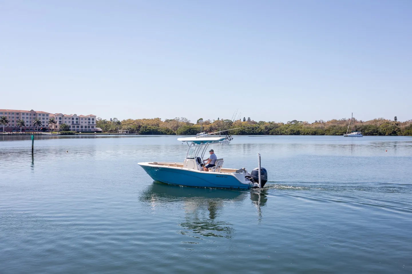 Two boats are in the water on a sunny day.